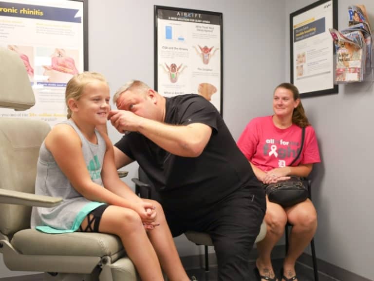 Dr Kurt Garren checking a pediatric patient's ear